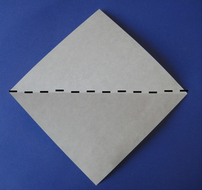 Place paper with colored side facing down
Fold it in half diagonally.
