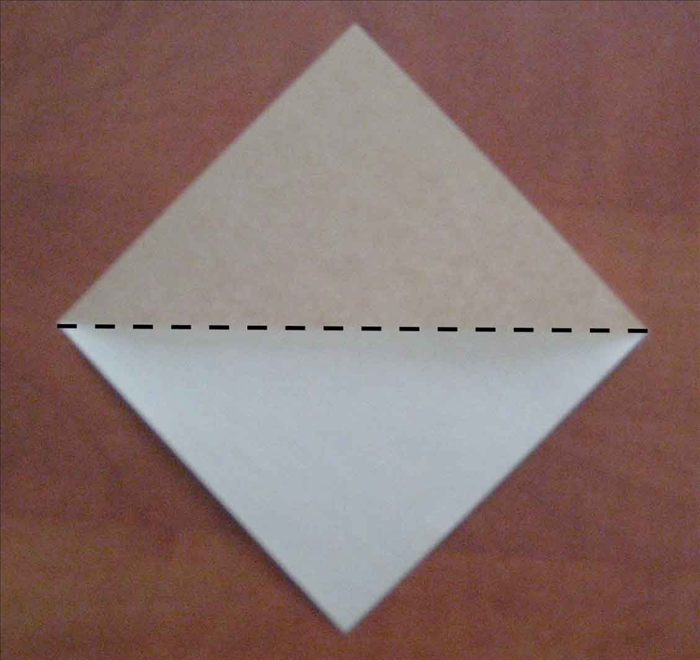 Skip to step 9 if you know how to fold the square base.

Place the paper with the points at the top, bottom and 
sides.
Fold in half horizontally and unfold.