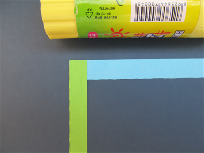 Glue the vertical strip on top of the left edge of the horizontal strip.
Make sure it is aligned at the side and top

