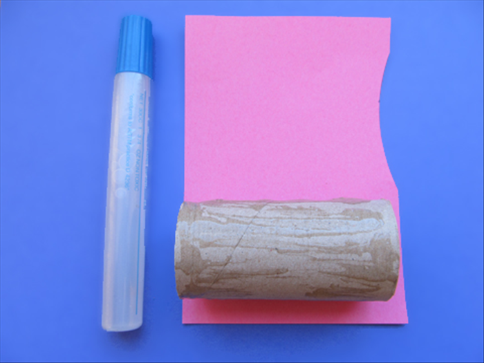 Coat the toilet paper roll with glue
Place it on top of the piece of paper the color you want the sides of the heart to be.
Roll up the paper and glue the edge closed
