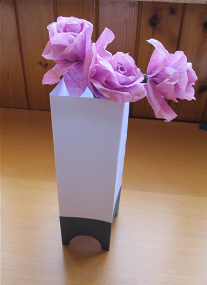<p> Materials:</p> 
<p> 1 peice of sturdy paper twice the height of the width - * This is a tall thin vase.  To make it shorter make the height of the paper shorter.</p> 
<p> 1 different color piece of sturdy paper the same width but 1/4 the height</p> 
<p> Round object</p> 
<p> Scissors</p> 
<p> Paper glue</p> 
<p> Pen or penci</p>