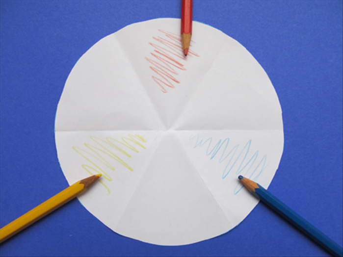 Unfold the circle. There should be 6 creases.

The primary colors are red, yellow and blue. There will be one in each triangle with a space between them.
You can mark the top and bottom side triangles to remember where to place them. See the picture
