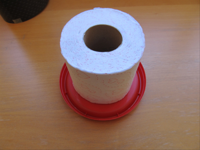 Check to see if one of the round plastic lids is slightly larger than the toilet paper roll. 