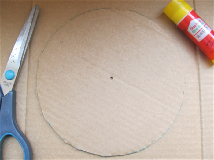<p> Take one of the cutout circles and trace the outline on cardboard.</p> 
<p> Cut out the circle.</p> 
<p> Now you have 4 circles with a hole in the center and the one circle you just traced without a hole in the center.</p> 
<p>  </p>