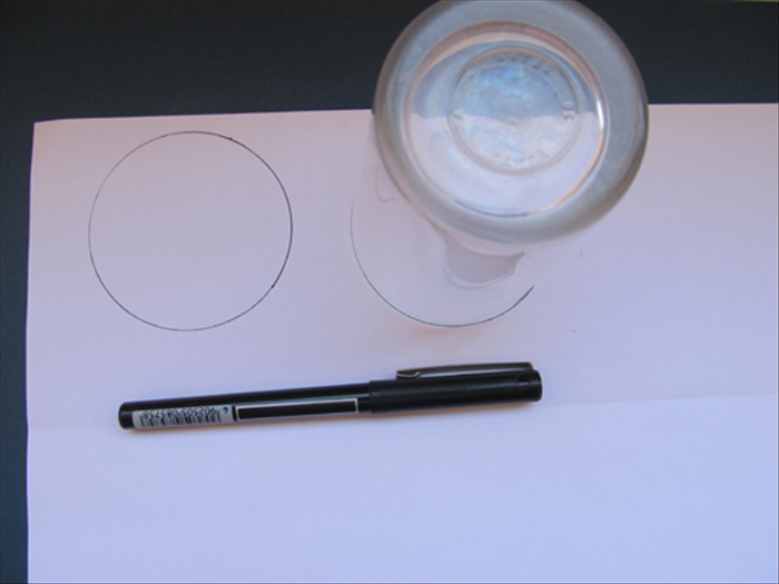 Trace the round object 2 times on scrap paper.
Cut out the circles
