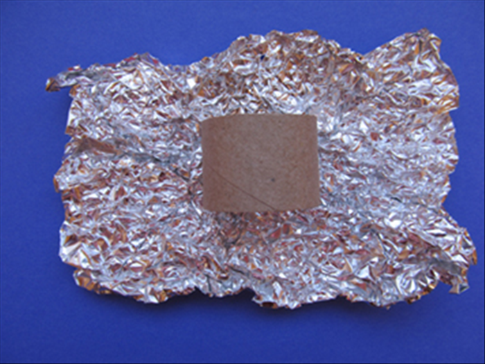 Open up the aluminum foil - not all the way and do not smooth it out
Place the tube you made in the center.