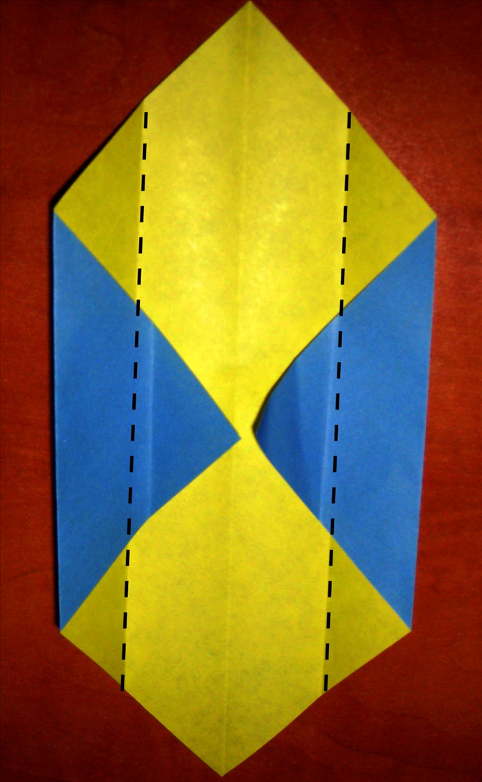 Fold the 2 sides to align with the center crease.
