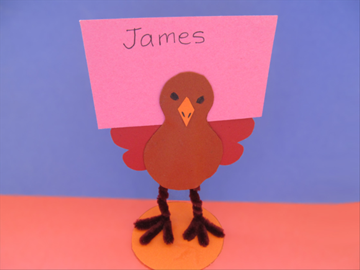 You stand-up turkey is ready.
Insert a name card behind the head.

Happy Thanksgiving! 

