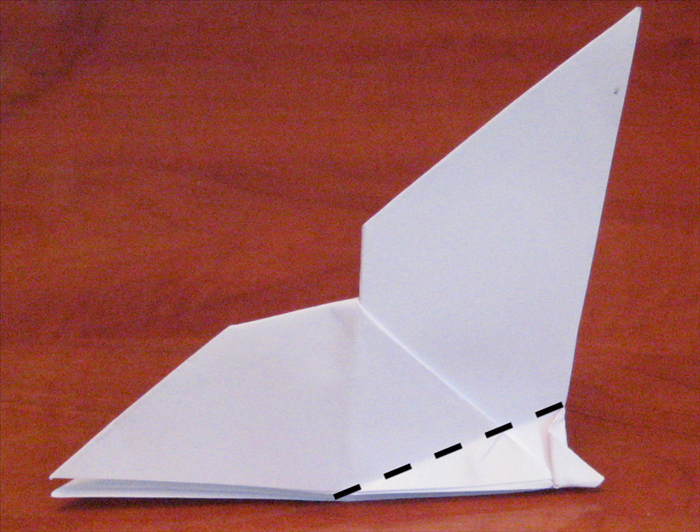 Fold a wing down at an angle.
Flip the paper over and repeat on the other side. Make sure the folded wings are aligned.
