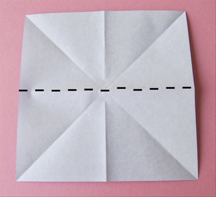 Flip the paper over to the back side

Fold it in half horizontally and unfold
Fold it in half vertically and unfold
