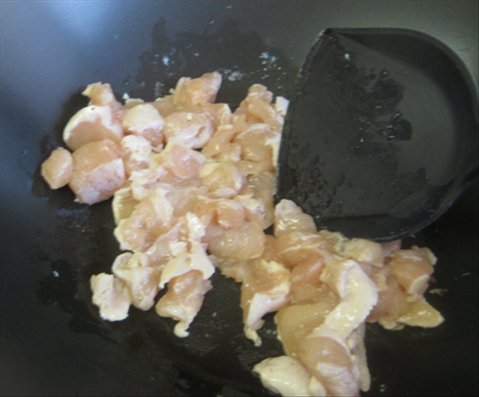 Stir fry the chicken in 2 tablespoons oil until it turns white
