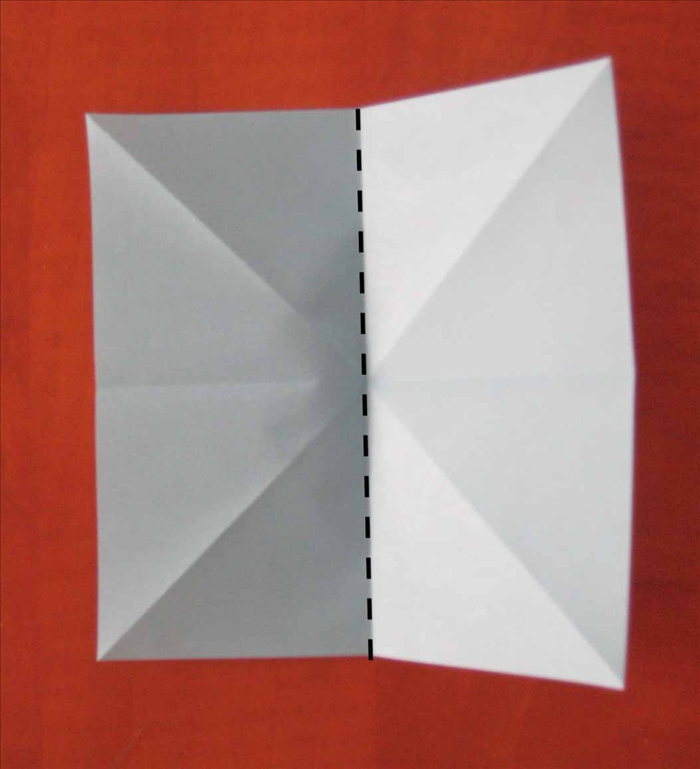 Fold the paper in half vertically and unfold