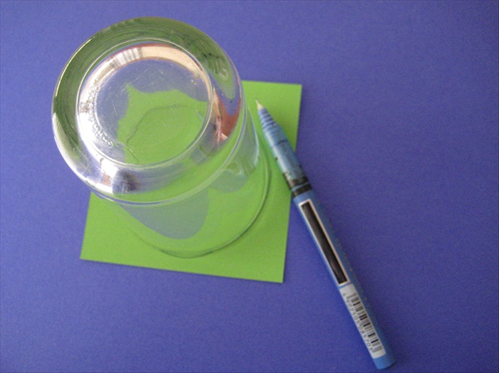 Trace a circle around a small to medium sized object. Cut it out and glue it to the center.