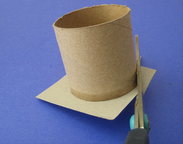 Make sure the glue has dried and then cut around the toilet paper roll.