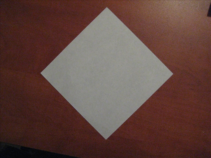 Place paper with the colored side facing down. 
The points should be on the top, bottom and sides.