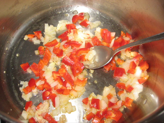 In a large pot fry the onion in oil until translucent.

Add the garlic and red pepper and fry 1 minute more

