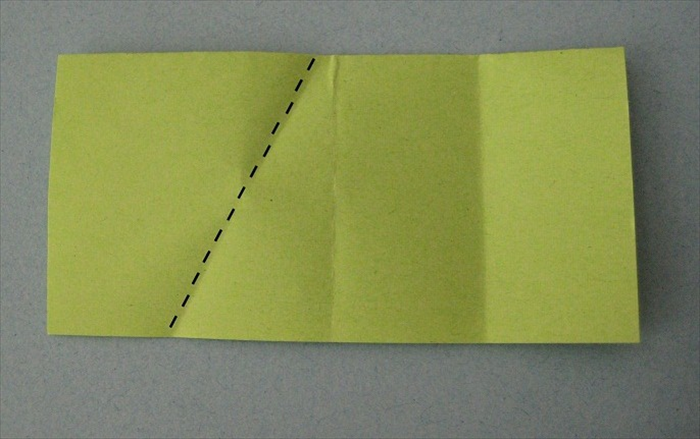 Place the paper on the table so that the open end is on the bottom.
Start at the middle crease and fold the left side down until its top point touches the crease line of the right side.
