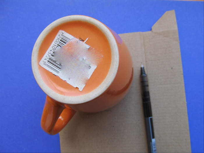 Trace the outline of the coffee cup or similar sized round object on cardboard and cut it out