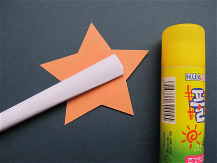Glue the end of the rolled paper to the back of one star.