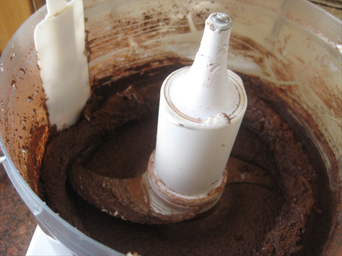 Add ½ cup cocoa.  Mix, then scrape the cocoa off the sides of the mixer and mix until blended