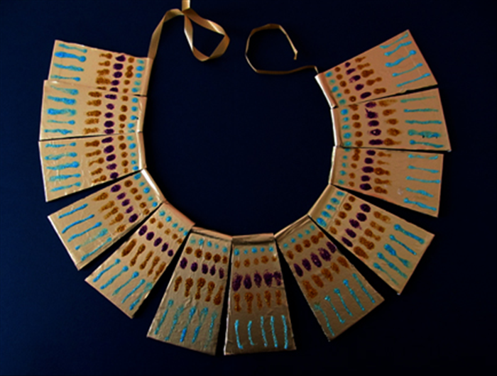 When dry insert a thin ribbon or string into the loops you made with the chopstick
Your Egyptian necklace is finished!
