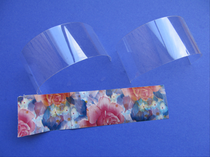 Cut 2 strips of the plastic and 1 strip of the paper  - 1 ½ inches wide  and  6 inches long 