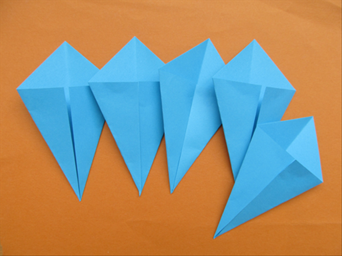 Fold the remaining 4 square papers the same way for a total of 5 kite shapes