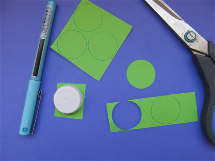 <p> Trace the bottle cap 6 times on colored paper.</p> 
<p> Cut out the circles.</p> 
<p>  </p>