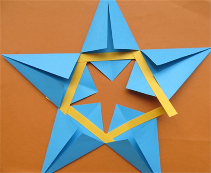 Rotate the star so that the next kite shape is on the right.
Repeat step 9

Repeat until you have glued all 5 kites.

When you get to the 5th kite glue both sides of the strip into the kites on both sides.
