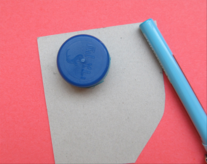 On a piece of cardboard draw a circle around the bottle cap or small circular object
Cut out the circle

