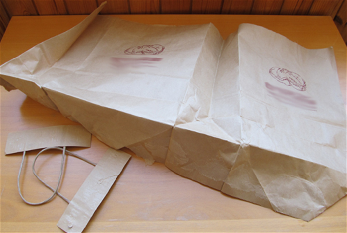 Open the paper bag and remove the handles