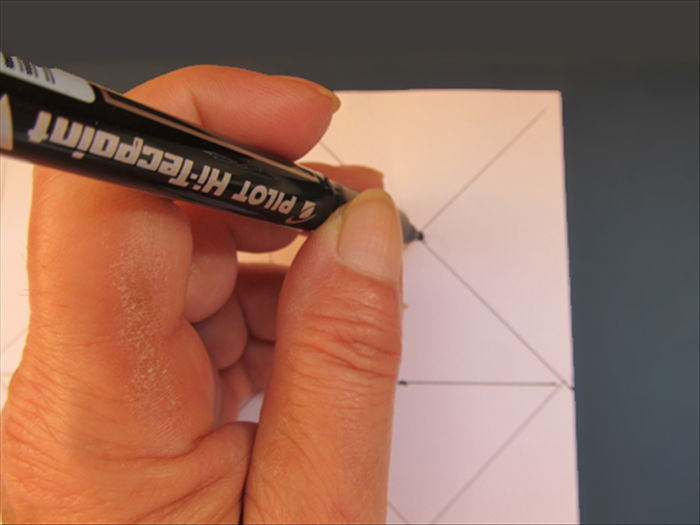 Align the scrap paper on top of the background paper.
Put the pen point through the hole to mark the 9 dots underneath.
