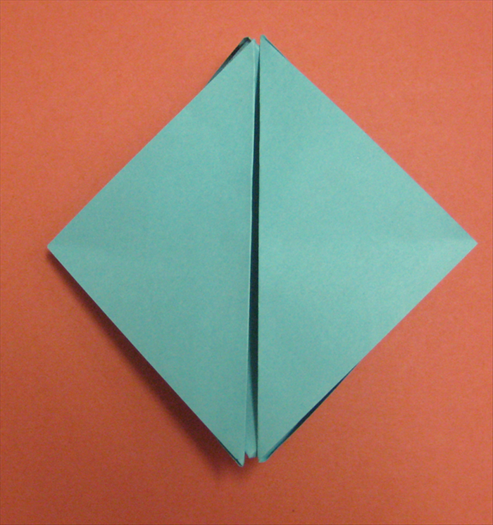 Stick your fingers between the 2 flaps at the center and pull them up.
See the next picture for result.
