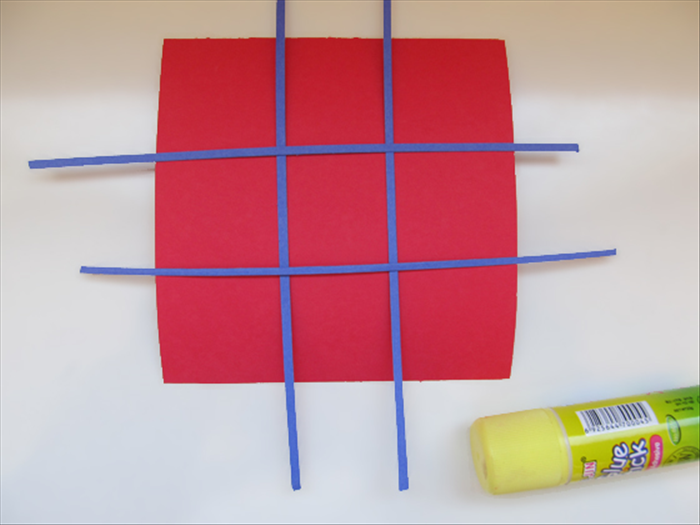 <p> Place 2 strips horizontally and 2 strips vertically. Adjust them to make 9 equal squares.</p> 
<p> Glue them in place.</p> 
<p>  </p>