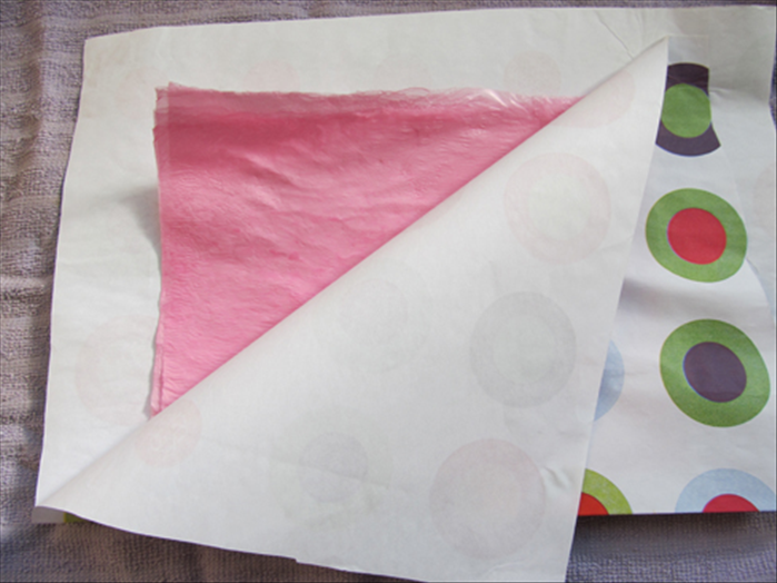 Lift the paper to see if the layers have fused together. If they haven’t fused, cover the bag again and go over it a few more times.

Flip the paper covered bag over to the back side and go over it some more.
Check to see the results and repeat if necessary
