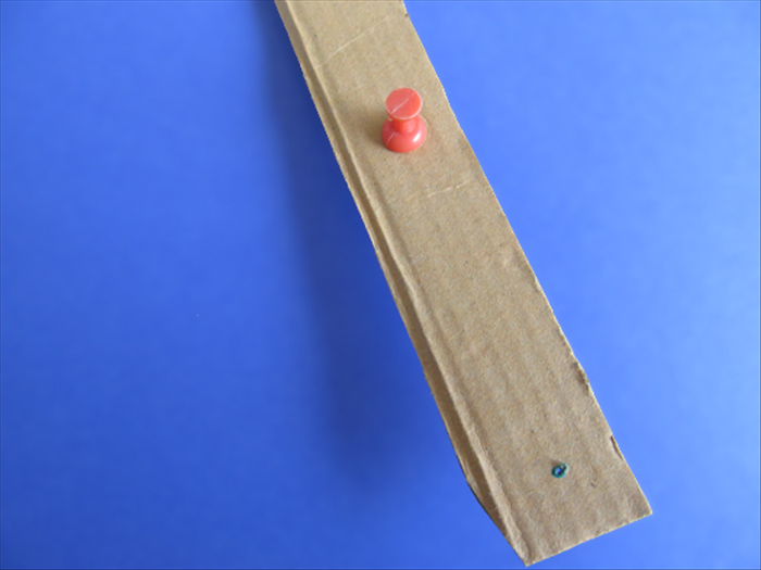 <p> Use the pointy nail or push pin to make a hole at each mark.</p> 
<p>  </p>