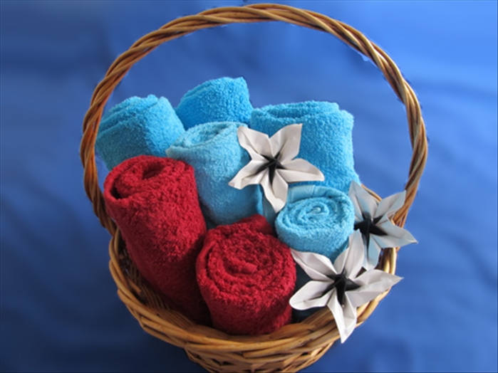 You can display or set up a gift basket with towels rolled to different heights.

If you are standing up the towels in a basket, keep the neat folded end on the top and the open edge in the back.

If you are laying them on top of each other, on a shelf, put the neat folded end in the front and place the open end on the bottom.

Enjoy!
