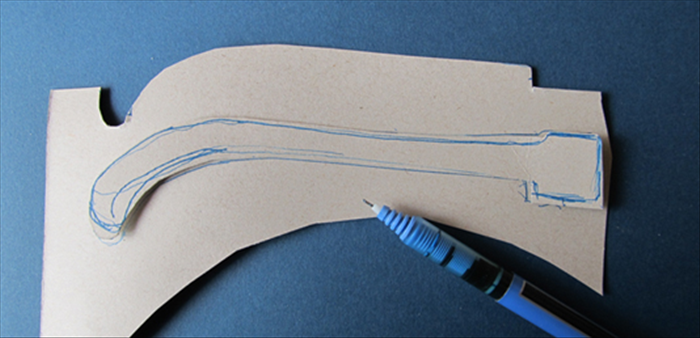 <p> Trace the cut out onto another piece of cardboard and cut out the second piece.</p>