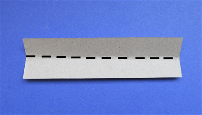 Take the 1 ½ inches x 5 ¾ inches strip and fold it in half lengthwise
