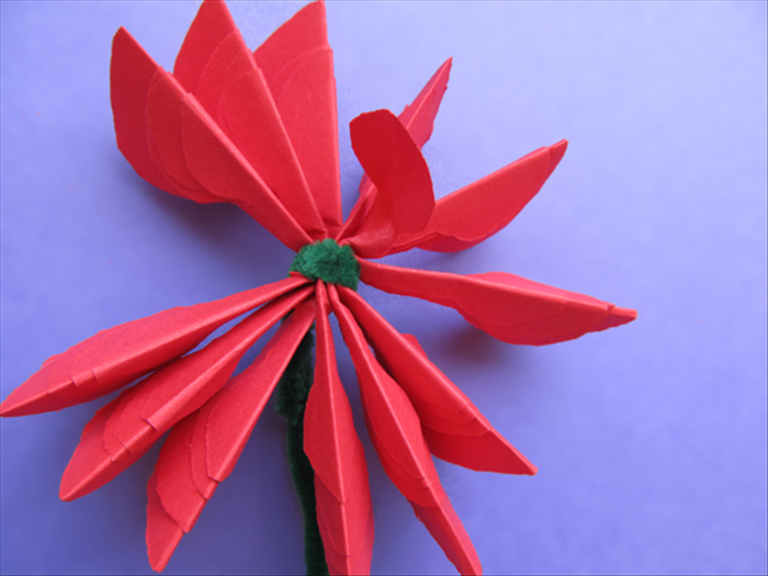 Bring the petals up and around the wound wire to make a circle

Lift one of the smallest petals and fold it back in the opposite direction

