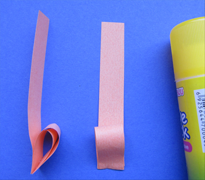 Align the straight edges with the last 2 strips and glue them in place- at the bottom only