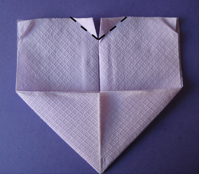 Flip the napkin over to back side.

Take the 2 top inner points and fold them down equally at an angle.
