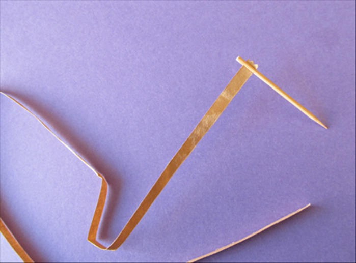 Put a strip into the slit of the toothpick