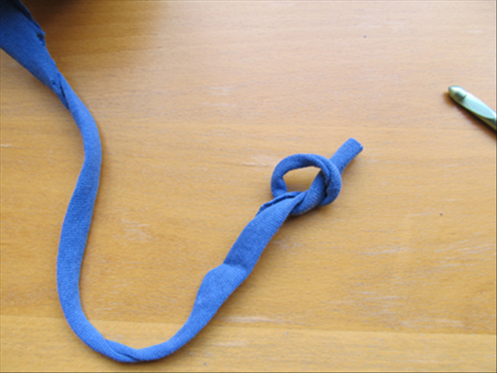 Make a loose knot at the end of the strip.