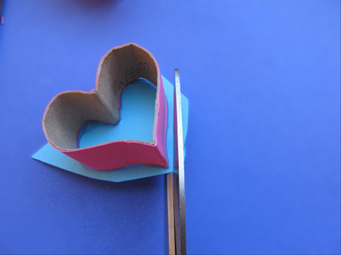 Cut the extra paper off along the edge of the heart shape.
