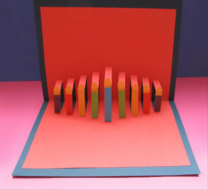 To make the Hanukkah pop-up candle card you need:
Thick paper 8 ½ inches X 12 inches    
Thick paper of a contrasting color 6 ½ inches X 13 ½ inches     
Small papers of different colors for the candles
Scissors
Ruler
