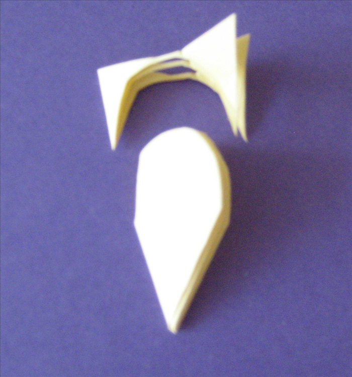  On the same paper cut a half oval starting from 1/3 – 1/2 of the way from the top
Continue cutting the top of the oval as close to the top as you can. Try to make the ½ oval shape equal on both sides.