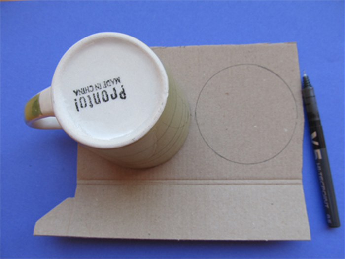Trace the large cup or similar sized round object 2 times on cardboard.
Cut out the 2 circles
