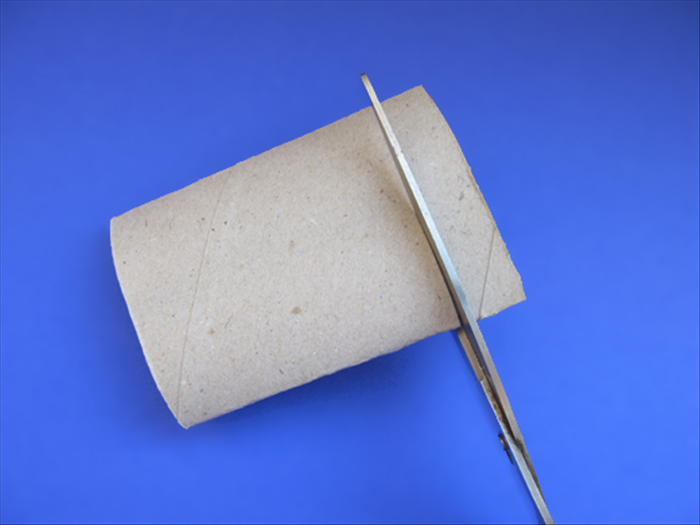 Press a toilet paper roll flat and cut a slice about ¾ the height of the rolled paper you just made.
Cut 1 slice for a napkin ring or 2 slices for a bracelet

