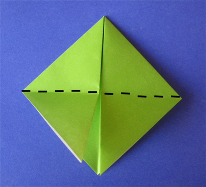 Rotate the paper so that the opening is on the bottom.

Fold the 2 flaps up to the top.
